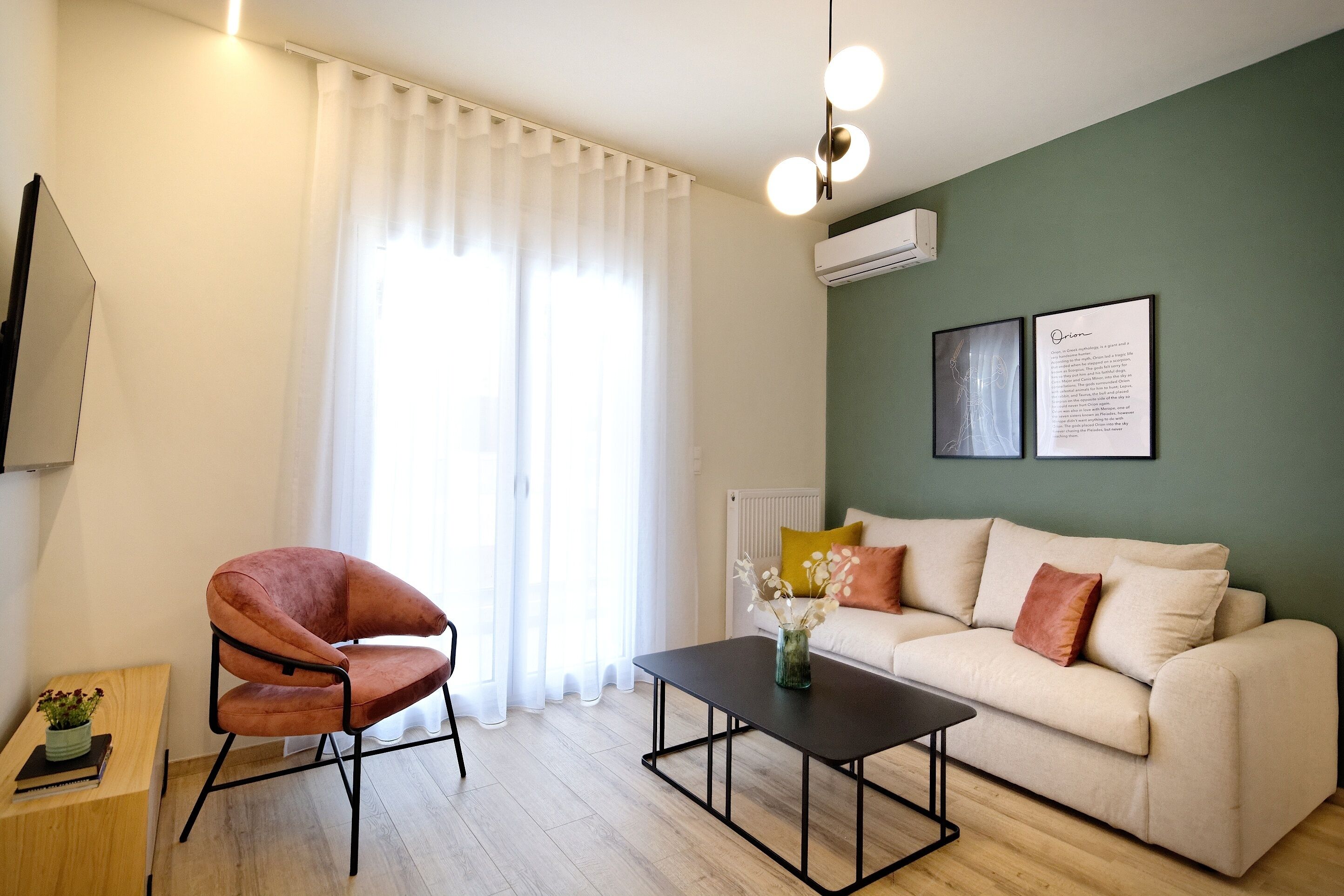 A modern living room with a sofa, a coffee table, a chair, and a window with curtains.