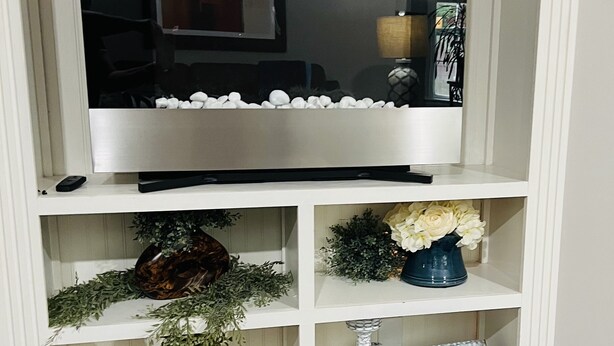 A white entertainment center with a flat-screen TV, decorative items, and a remote control. - 10min from MIZZOU/Univ Hospital/downtown! Family sized, CLEAN! Short term avail! (Columbia)
