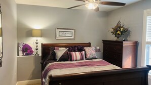 A bedroom with a bed, a ceiling fan, a nightstand, a dresser, and a window with blinds. - 10min from MIZZOU/Univ Hospital/downtown! Family sized, CLEAN! Short term avail! (Columbia)