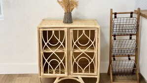 A room with a wooden console table, a wicker basket, and a wire shelf unit. - Boho Beach Villa- minutes to the ocean  (Vero Beach)