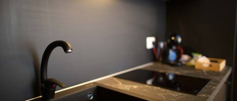 A modern kitchen with a sleek faucet and a marble countertop.