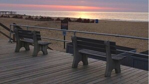 A wooden boardwalk with benches overlooking a beach at sunset. - FALL 2026 Gorgeous Renovation-Walk to Beach, Asbury, Pets Welcome! (Neptune Township)