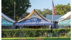 A tented structure with a flag, surrounded by well-maintained hedges and flowering plants. - FALL 2026 Gorgeous Renovation-Walk to Beach, Asbury, Pets Welcome! (Neptune Township)