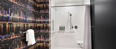 A modern bathroom with a cityscape wallpaper, a walk-in shower, and a white towel hanging on a rack.