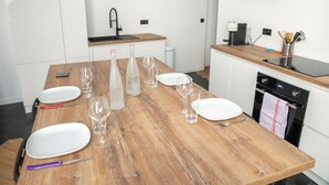 A kitchen with white cabinets, a wooden countertop, a sink, and a stove. - Le Saint Firmin - Two Bedroom Apartment, Sleeps 4 (Montpellier)