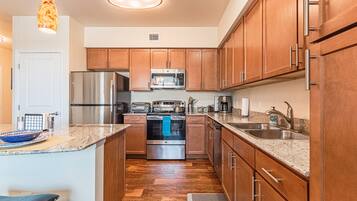 Deluxe Apartment | Private kitchen | Dining tables