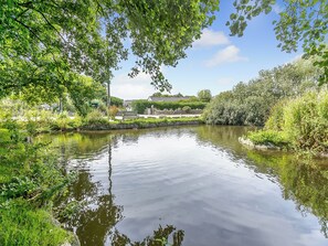 A calm river with a bench and greenery. - 20 Blackbird Cottage-UK38935 (Lands End, near Porthcurno)