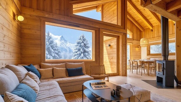 A cozy log cabin interior with a sofa, coffee table, and dining area. - Cosy chalet with views of Mont Blanc (Chamonix-Mont-Blanc)