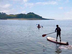 A calm lake with kayaks and a paddleboarder. - Drumwall - Sea Glass (Gatehouse of Fleet)