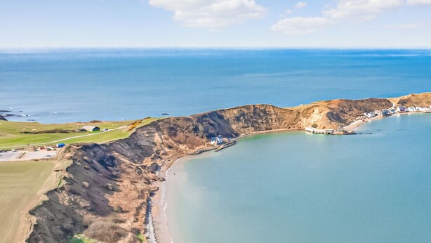 An aerial view of a coastal area with cliffs, a beach, and a small settlement. - Min y Traeth (By the Beach) (Morfa Nefyn, near LLyn Peninsula)