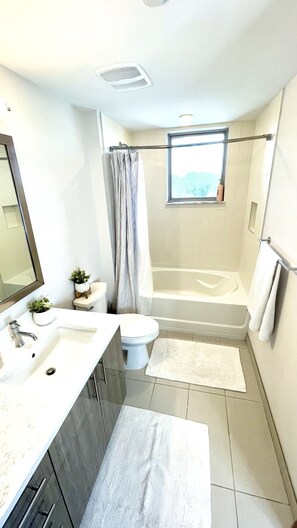 Combined shower/bathtub, hair dryer, towels, soap