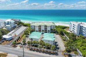 A hotel with a central building and a beach view.