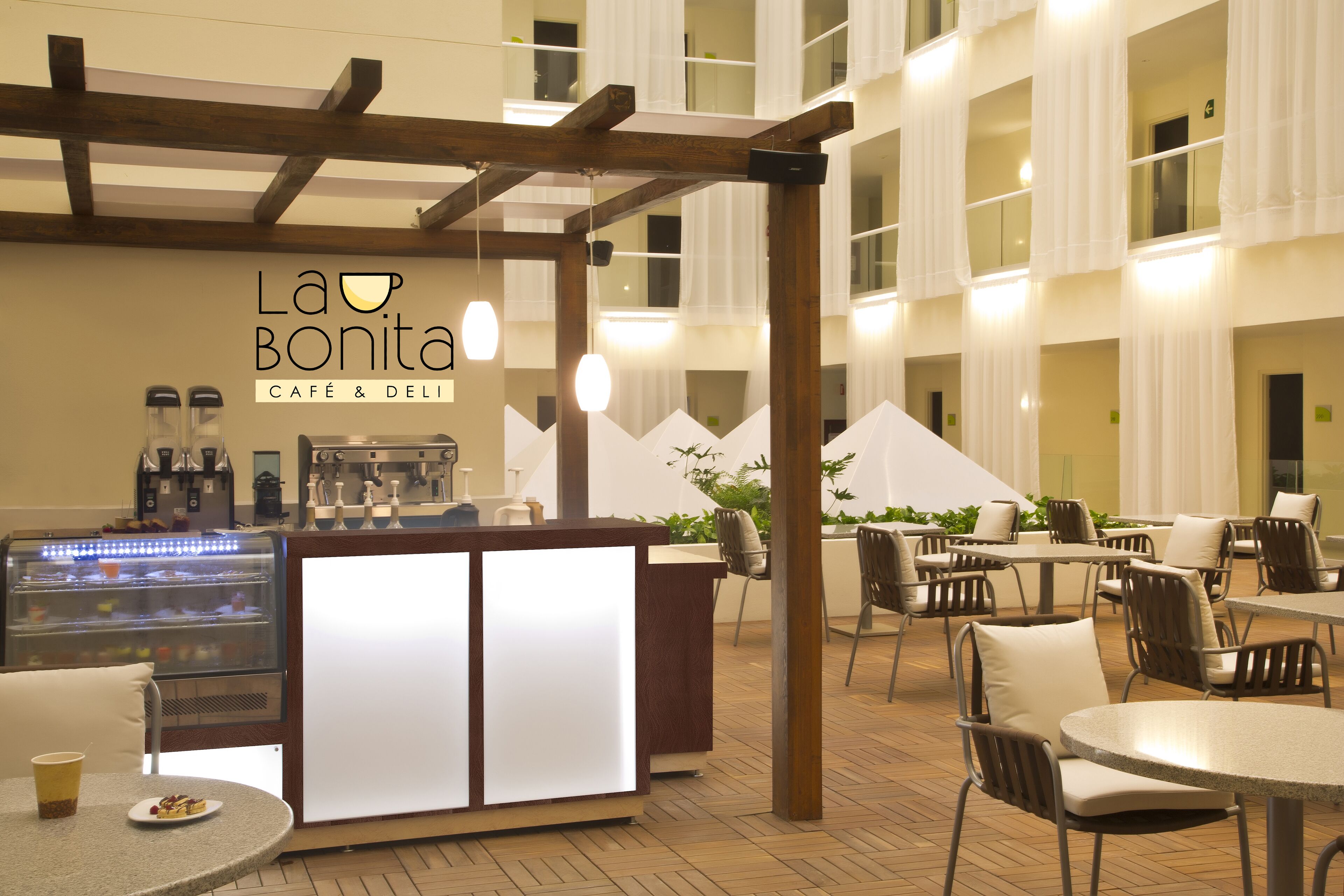 A café area with a counter, chairs, and tables.