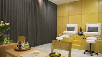 Relax in a serene spa room with a large curtain, seating area, and soothing ambiance.