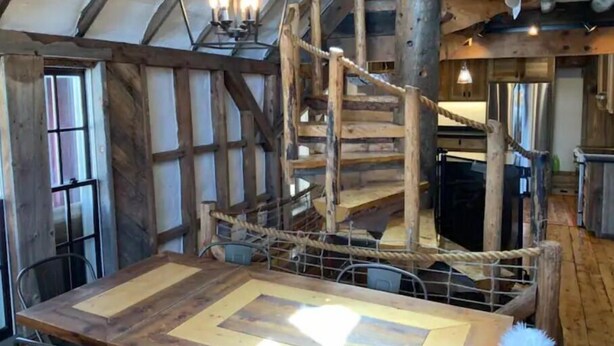 A rustic interior with a wooden staircase, a dining table, and a chandelier. - Most UNIQUE Luxury Prop in CB, Dogs ok, ski locker (Crested Butte)