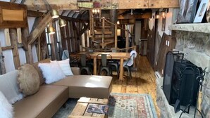A rustic cabin interior with a wooden dining table, a sofa, and a small wooden chest. - Most UNIQUE Luxury Prop in CB, Dogs ok, ski locker (Crested Butte)