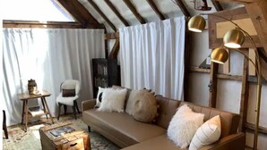 A cozy living room with a sofa, a small table, and a lamp. - Most UNIQUE Luxury Prop in CB, Dogs ok, ski locker (Crested Butte)