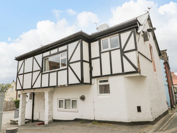A traditional half-timbered house with a white facade and black timber framing. - Daisy's Den (Whitby)