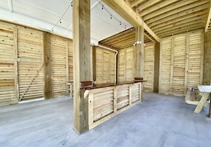 Enter a spacious hall with a high ceiling and wooden floor, flanked by paneling and a central counter.
