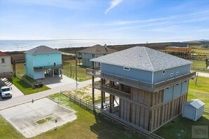 Enjoy a serene beachfront view from the upper-level balcony of this coastal property.