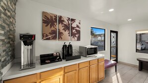 A modern kitchen with a coffee machine, a microwave, and a coffee station. - Red Roof Inn Los Angeles – Bellflower (Bellflower)