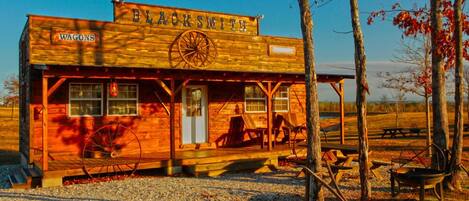 A rustic wooden building with a sign reading "Blacksmith."