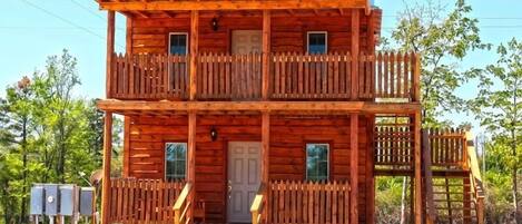 A wooden building with a sign reading "Undertaker" and a balcony.
