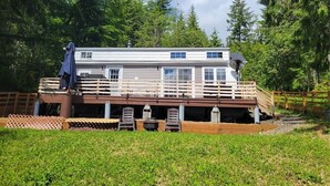 Une cabane dotée d’une terrasse, d’un espace salon extérieur et d’une zone abritée.