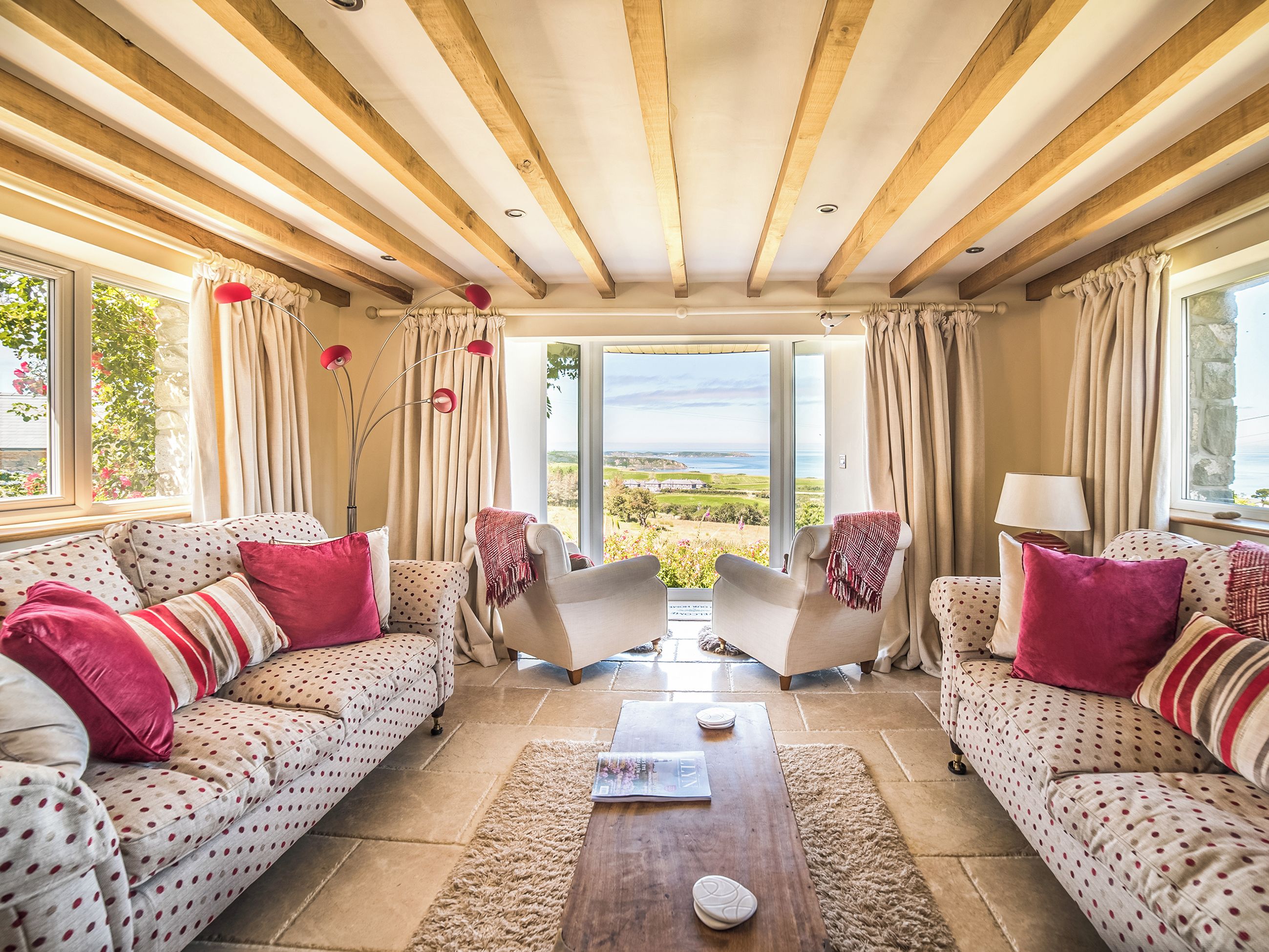 Een kamer met twee banken, een salontafel en uitzicht op de omgeving.