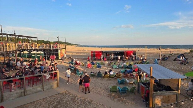 A beachside market with stalls and seating areas. - Private King Studio Close to the Action and Recently Renovated (Muskegon)