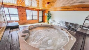 A hot tub in a wooden cabin with a view of the outside through large windows. - Luxe Downtown Winter Park Condo + Hot Tubs - 3 Full Baths -  Steps to Shuttle (Winter Park)