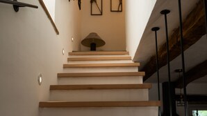 A wooden staircase with a white wall and a hanging lamp. - Romantic istrian stone house (Pracana, Buzet)
