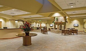 Welcome to our lobby, where a warm fireplace and elegant seating areas invite relaxation.