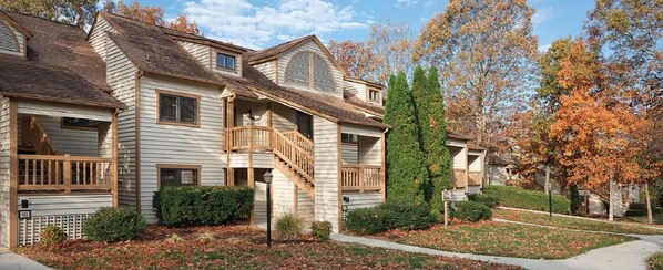 Traditional home with a front porch and well-manicured lawn.