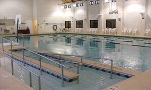 Relax by the pool, surrounded by comfortable seating and a secure, well-maintained space.