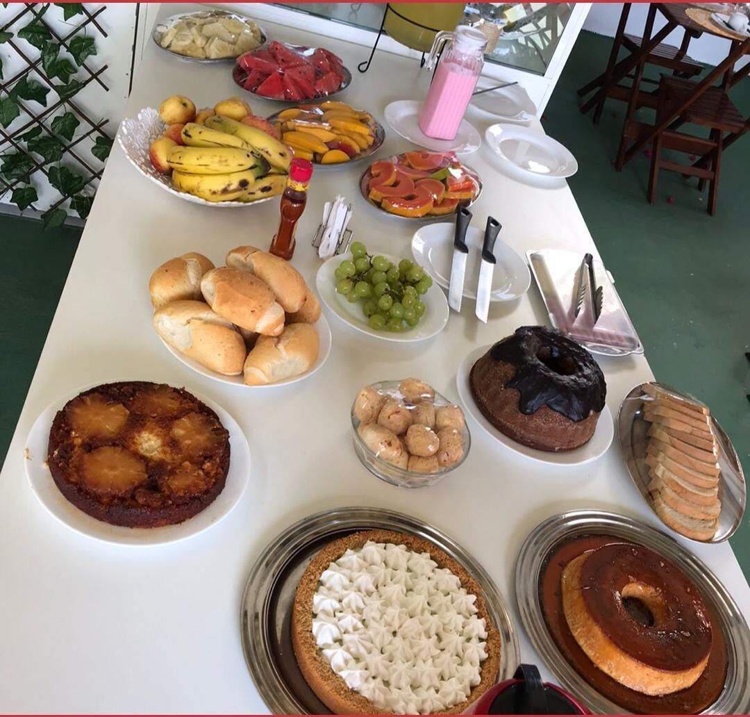 A buffet table with various food items including fruits, pastries, and desserts.