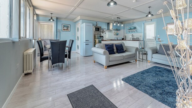 A spacious living room with a dining area, kitchen, and a large window. - 3 Ladyknowe - UK39969 (Moffat)