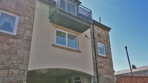 A two-story house with a garage. - 2 bedroom accommodation in Seahouses (Seahouses)