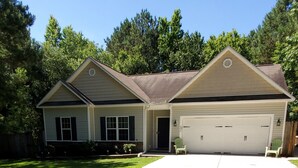 A two-story house with a garage, a front lawn, and a driveway. - Horse Ranch Getaway (Richlands)