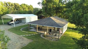 A two-story house with a covered patio, a garage, and a lawn. - Lake Front Gated Property  Private Dock 
Book 3 Nights - Get 4th Night Free.  (Wills Point)