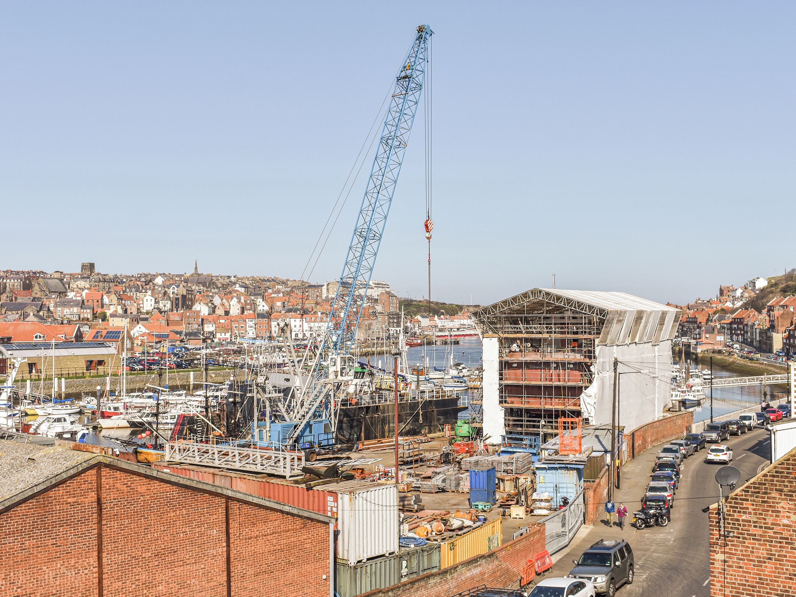 A construction site with a crane and a partially built structure.