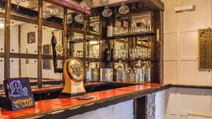 A bar area with a Murphy's Irish Stout tap, a McEwan's Lager sign, and a variety of glassware and bottles on shelves. - Situated in Whitby’s old town. (Whitby)
