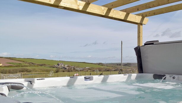 Un jacuzzi con vistas a un paisaje rural.