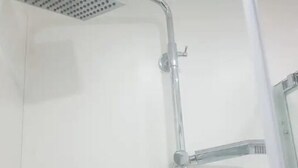 Ducha con cabezal de ducha de mano y cabezal fijo.