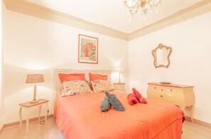 A bedroom with a bed, a nightstand, a dresser, a mirror, and a chandelier. - La Maison Vintage by Winkyhouse Cassis (Cassis)