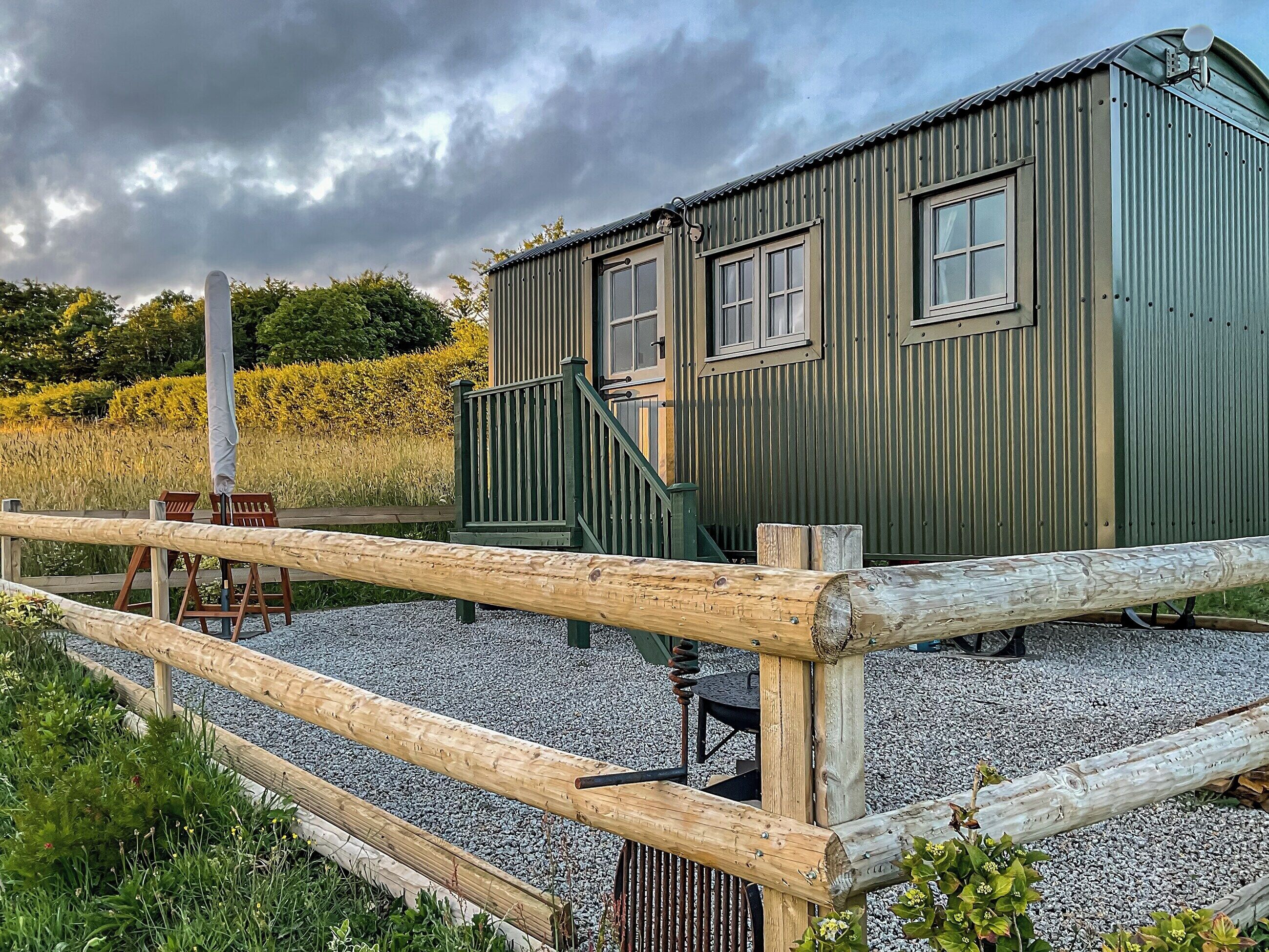 This bespoke shepherds hut is located on a working farm with alpacas and has stunning views.