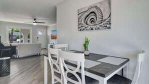 A dining area with a table, chairs, and a cactus plant.
