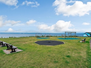 A park with swings, a shaded area, and benches. - 1 bedroom accommodation in Pittenweem (Pittenweem)