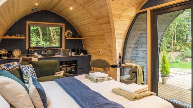 A cozy bedroom with a large bed, a desk with a mirror, and a view of the outdoors. - Peace and quiet, sat in the middle of your own field with a private hot tub. (Leadburn, near West Linton)
