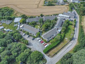 Une vue aérienne d’un quartier résidentiel comprenant plusieurs maisons, un parking et une route.